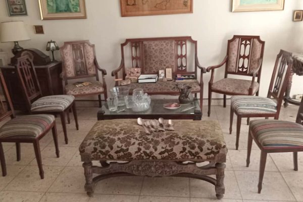 Sillón 3 cuerpos con respaldo esterillado; par sillones de sala, sillón 2 cuerpos estilo Inglés, 4 sillas, 2 sillas Chippendale tapizadas en pana bordó; sillas Windsor, estilo Francés, estilo Inglés; mesas auxiliares: tapa vítrea rectangular patas de madera tallada, de sala madera tallada estilo Inglés, pequeña mesa oriental doble plano, de fórmica vintage; mueble bajo 2 puertas 2 cajones con tapa mármol...