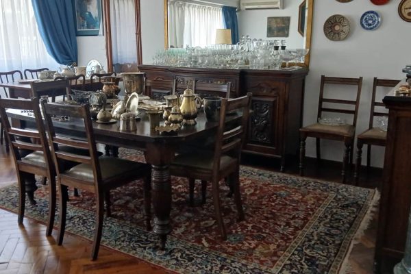 Sofá de 4 cuerpos en pana azulina; par sillones 1 cuerpo; 3 sillas; mesa auxiliar tapa de mármol cuadrada, otra tapa vítrea; mueble recibidor con espejo y percheros estilo Inglés; comedor diseño: mesa con 6 sillas; otro comedor estilo Inglés; mesa, 8 sillas; vajilleros tallado con herrajes de bronce, grande y chico; escritorio estilo Americano; silloncitos con ruedas; cómoda estilo Inglés tapa de mármol...